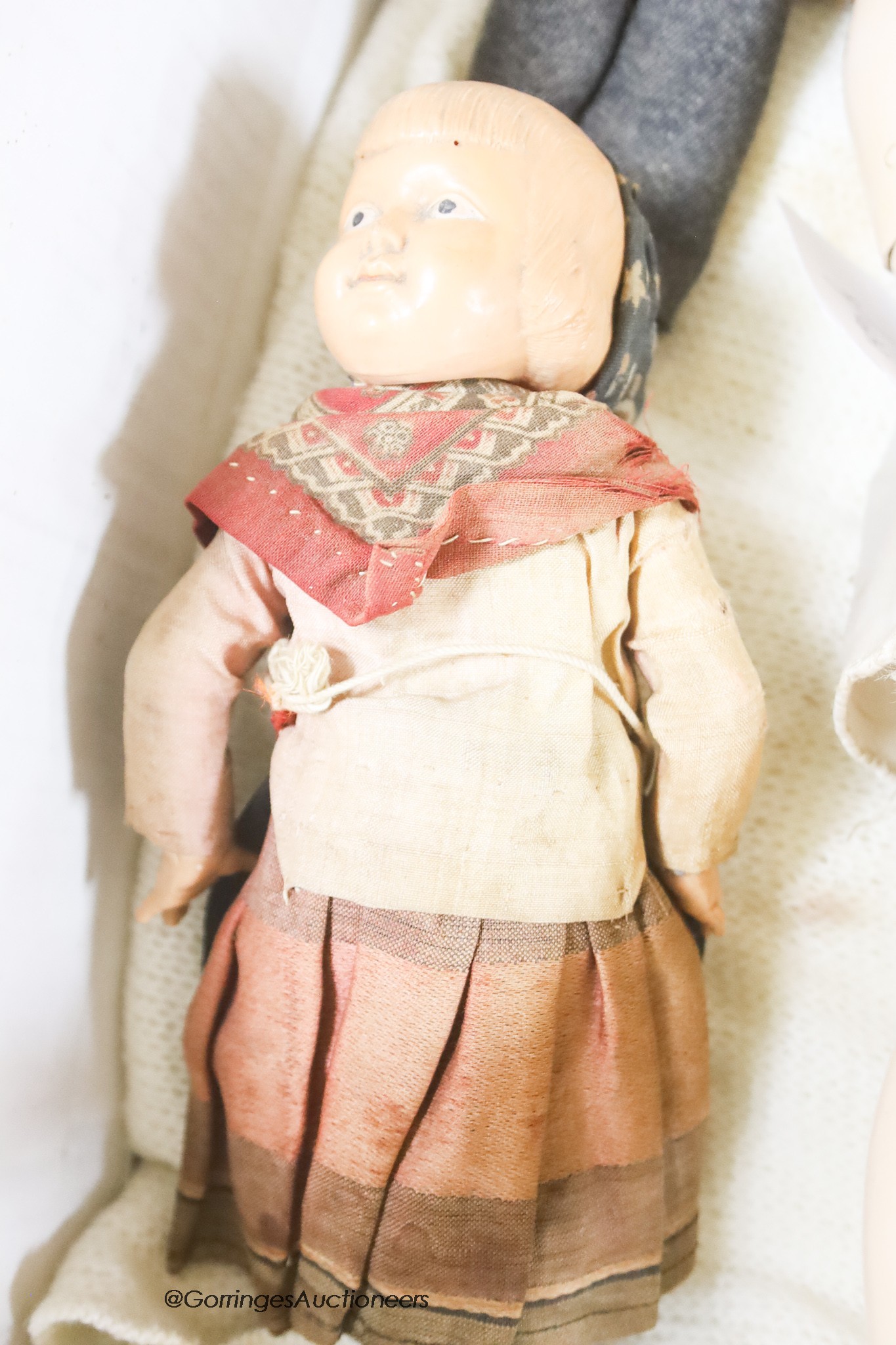 A bisque headed doll, believed by family repute to have been Princess Beatrice's and two celluloid dolls